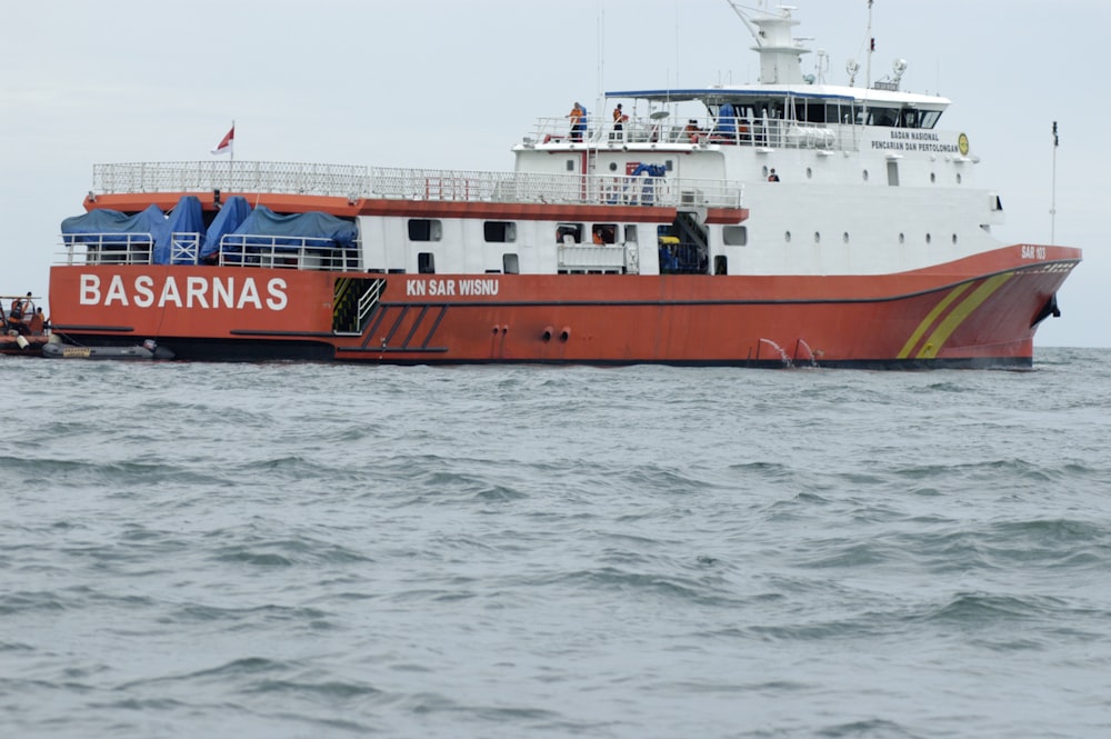 red and white ship on sea during daytime