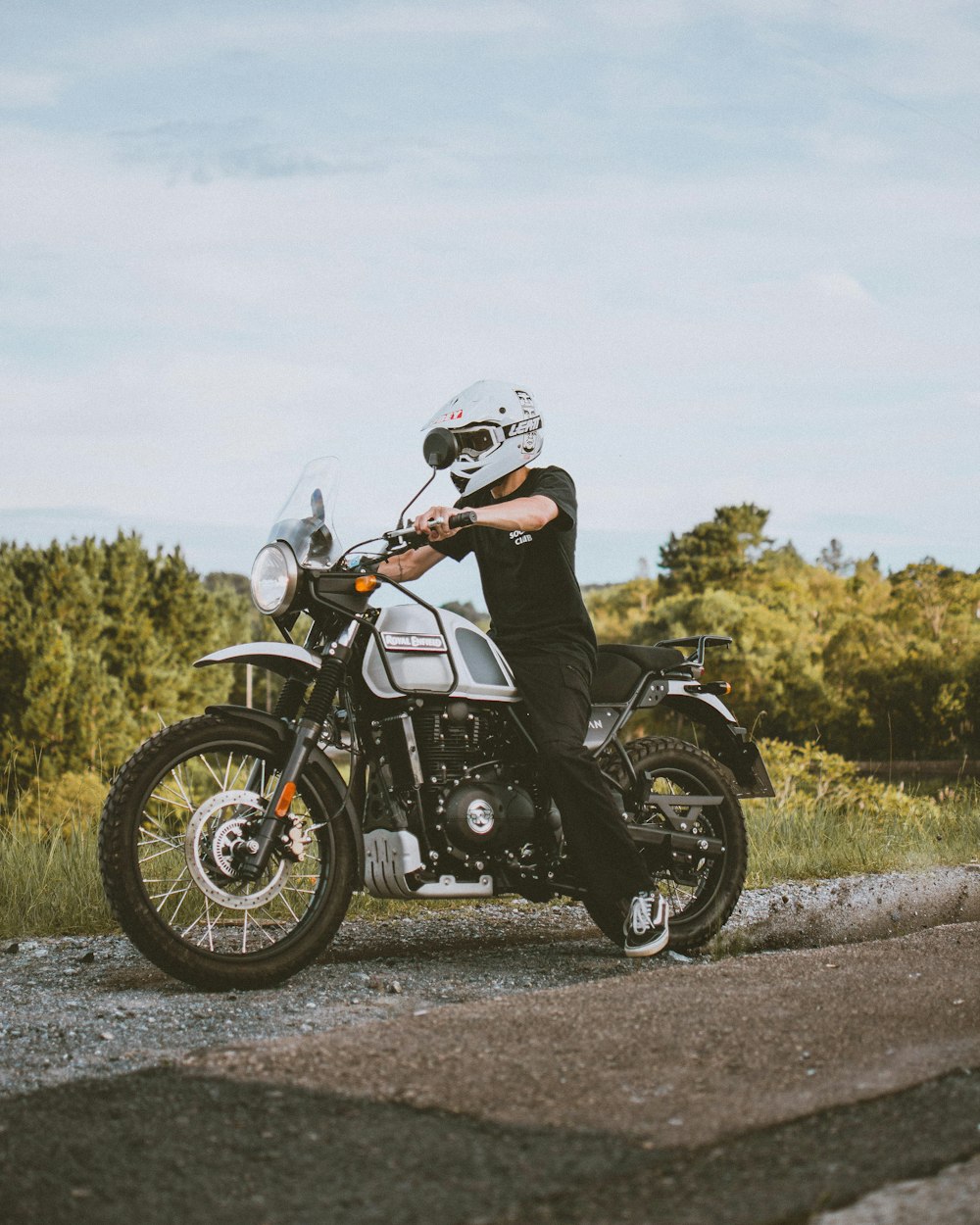 man in black helmet riding black motorcycle on road during daytime