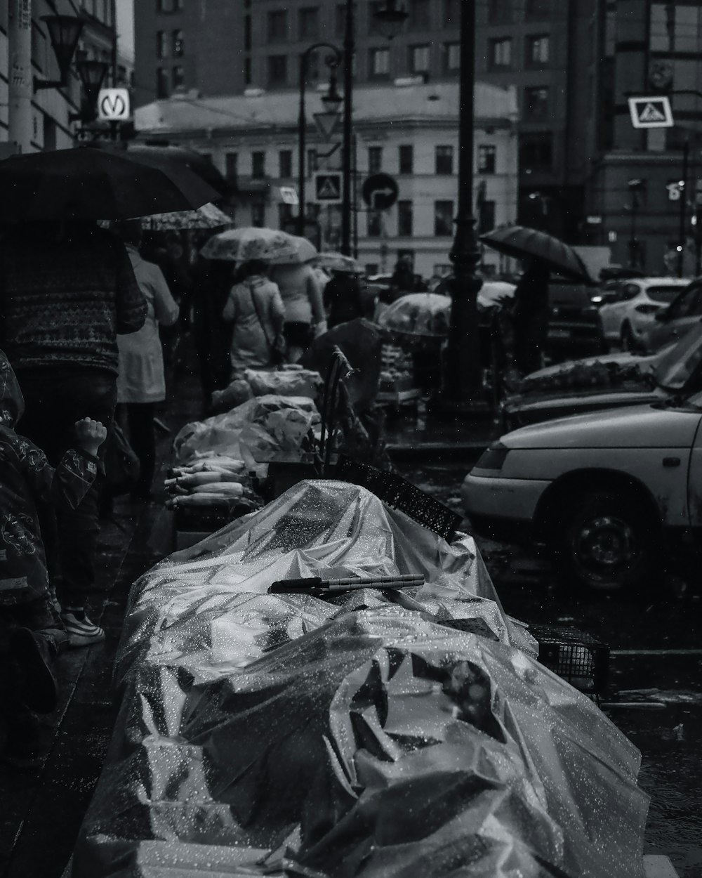 grayscale photo of people walking on sidewalk