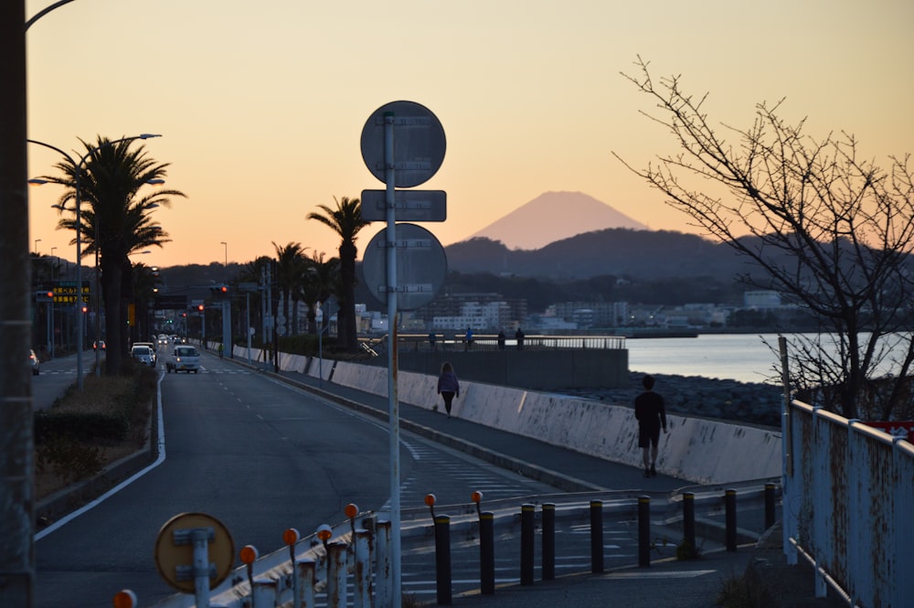 black street lamp near body of water during daytime