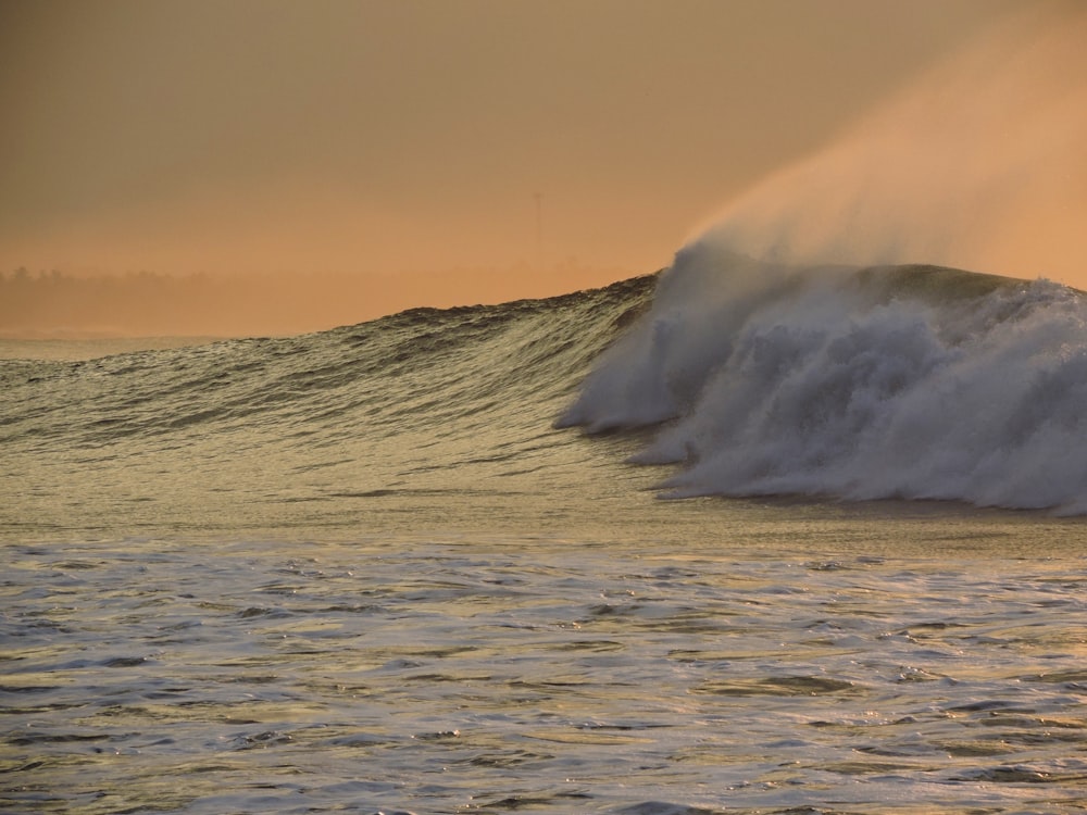 ocean waves crashing on shore during daytime