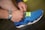 blue and white nike athletic shoe