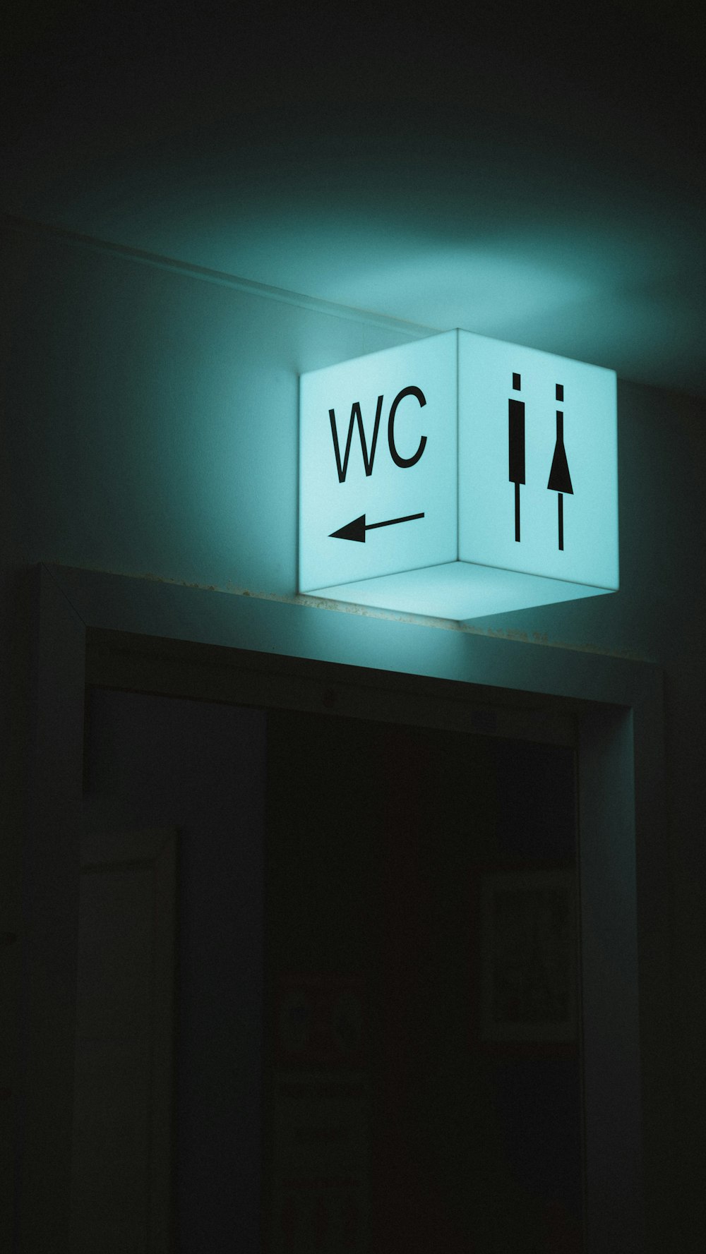 white and blue wall mounted exit sign