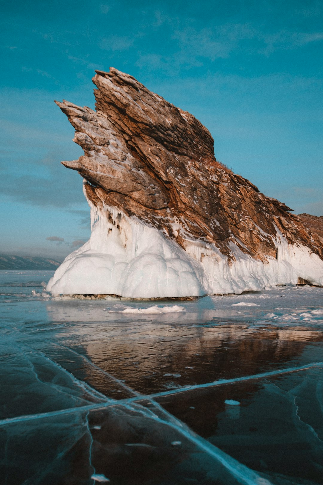 brown rock formation on blue sea under blue sky during daytime