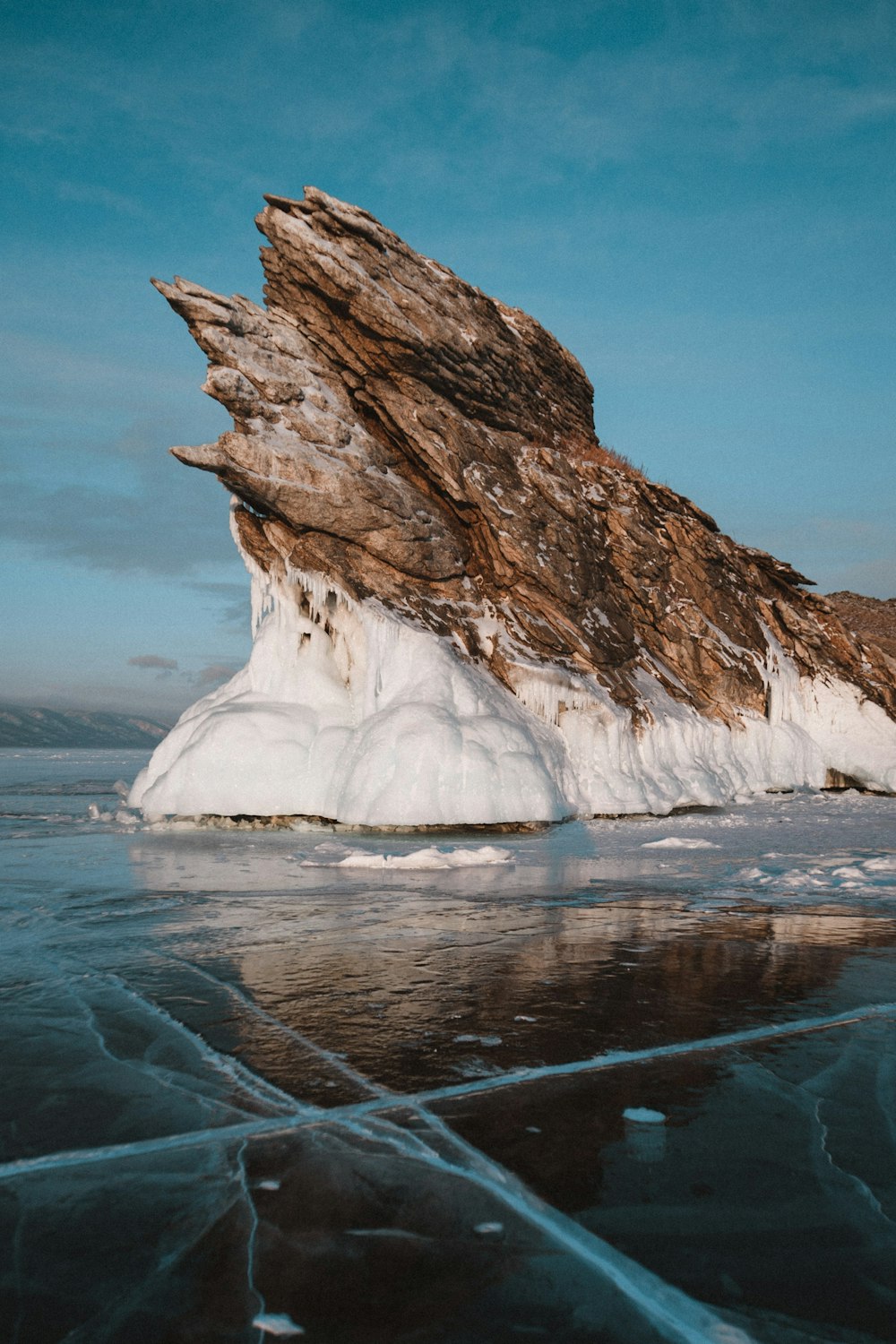 brown rock formation on blue sea under blue sky during daytime