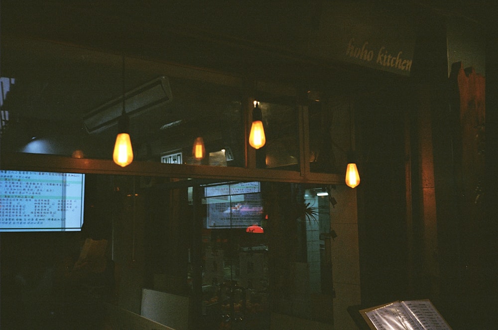 yellow pendant lamps turned on during nighttime