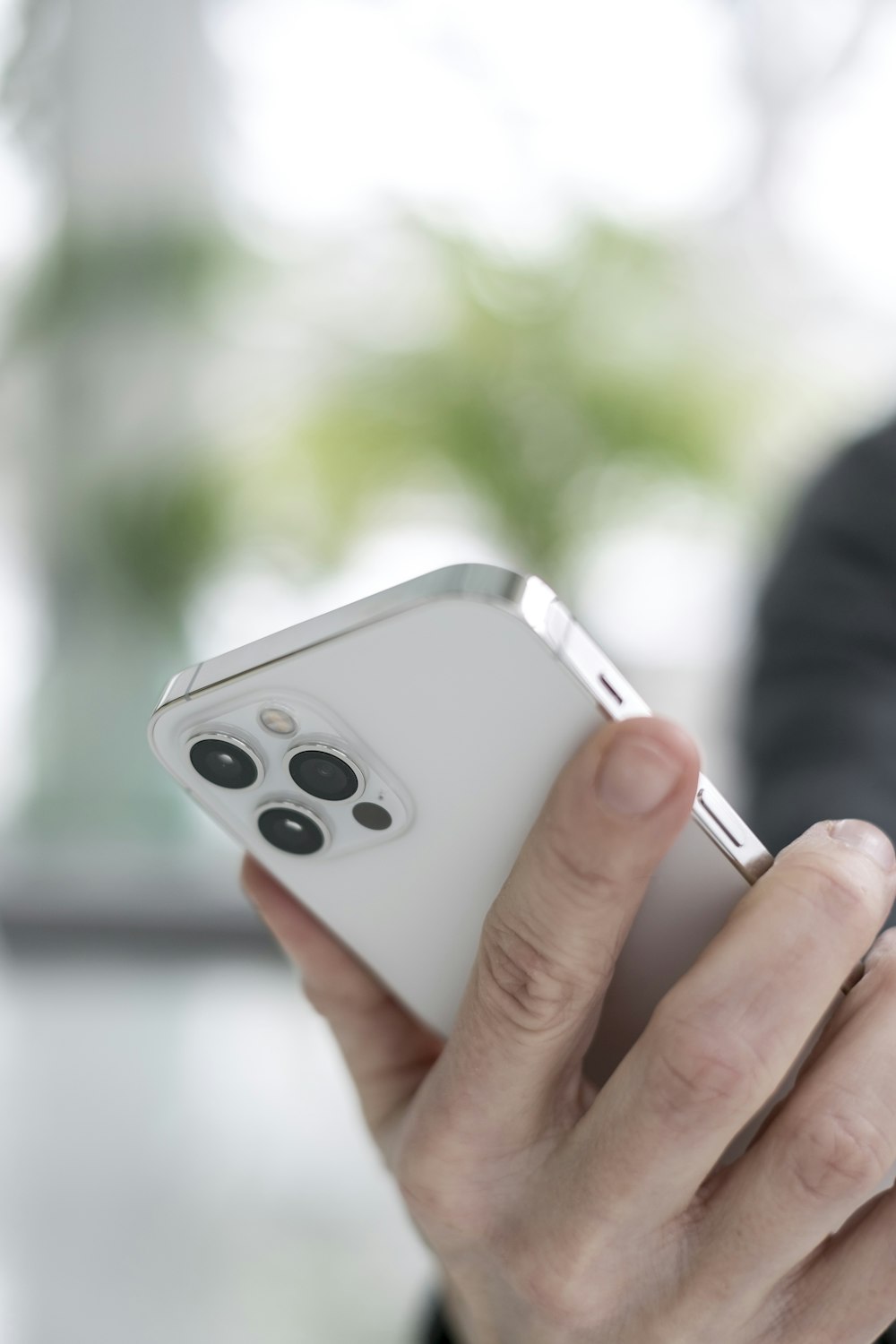 person holding silver apple remote