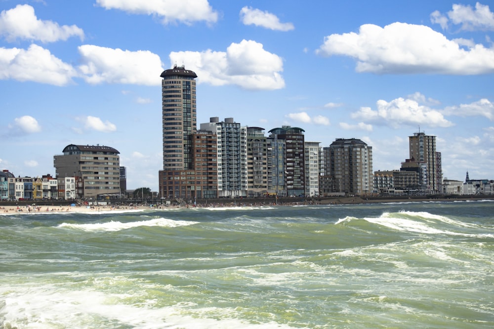 high rise buildings near sea under blue sky during daytime