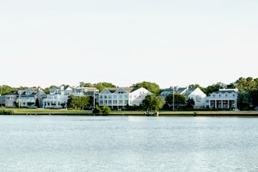 white and green house near body of water during daytime