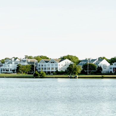 white and green house near body of water during daytime