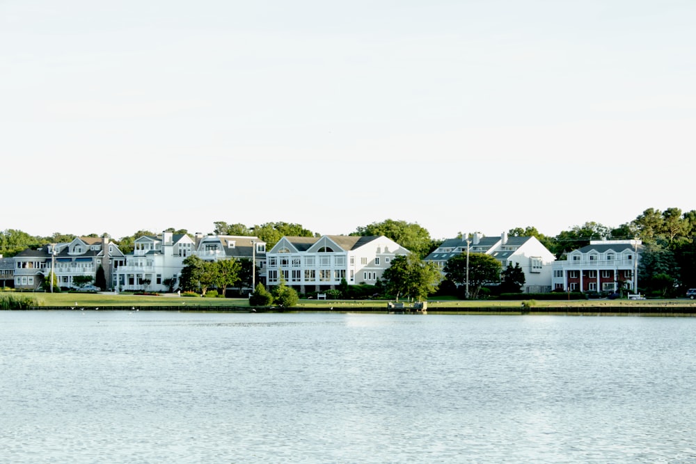 white and green house near body of water during daytime