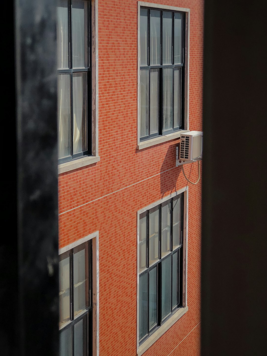 brown brick building with white window