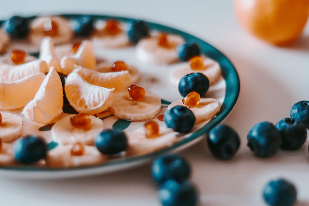 sliced of orange fruit on white and blue ceramic plate