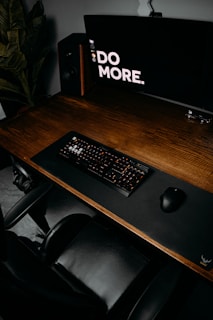 black computer keyboard on brown wooden desk