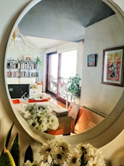 A beautifully arranged living room featuring a large decorative mirror.