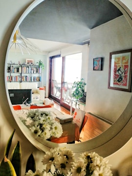 A beautifully arranged living room featuring a large decorative mirror.