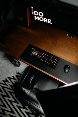 Overhead shot of a stylish desk setup with a mousepad showing a black and white geometric pattern.