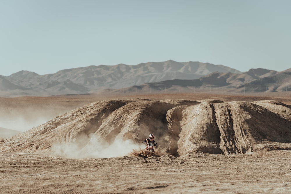 people riding horses on brown field during daytime