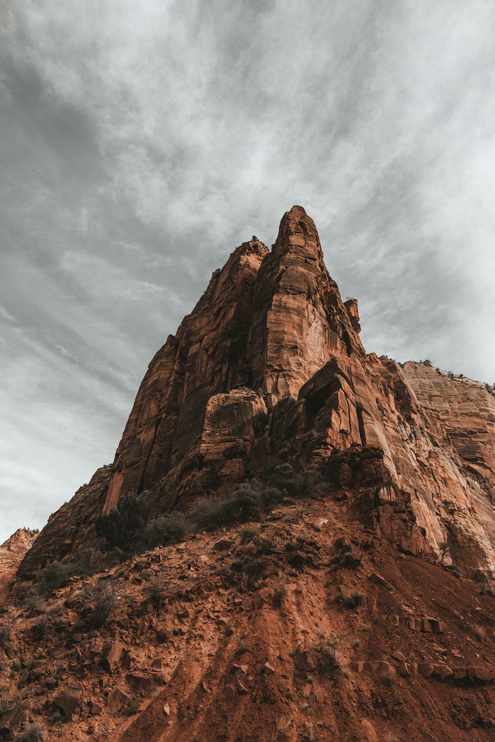 brown rock formation under white clouds during daytime