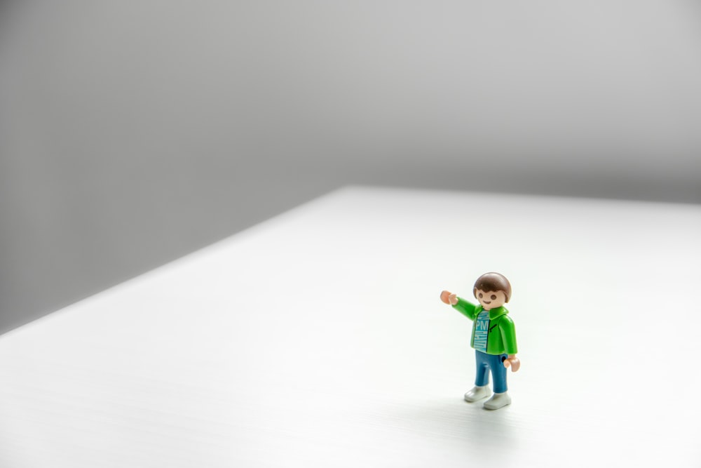 boy in green shirt and green pants figurine