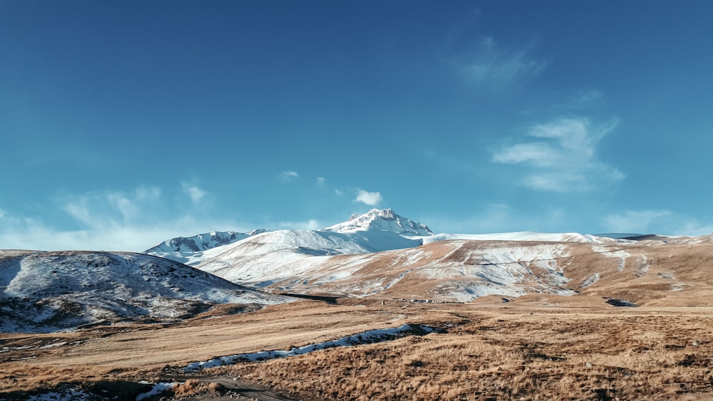 snow covered mountains under blue sky during daytime