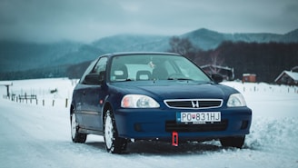 black honda sedan on snow covered ground