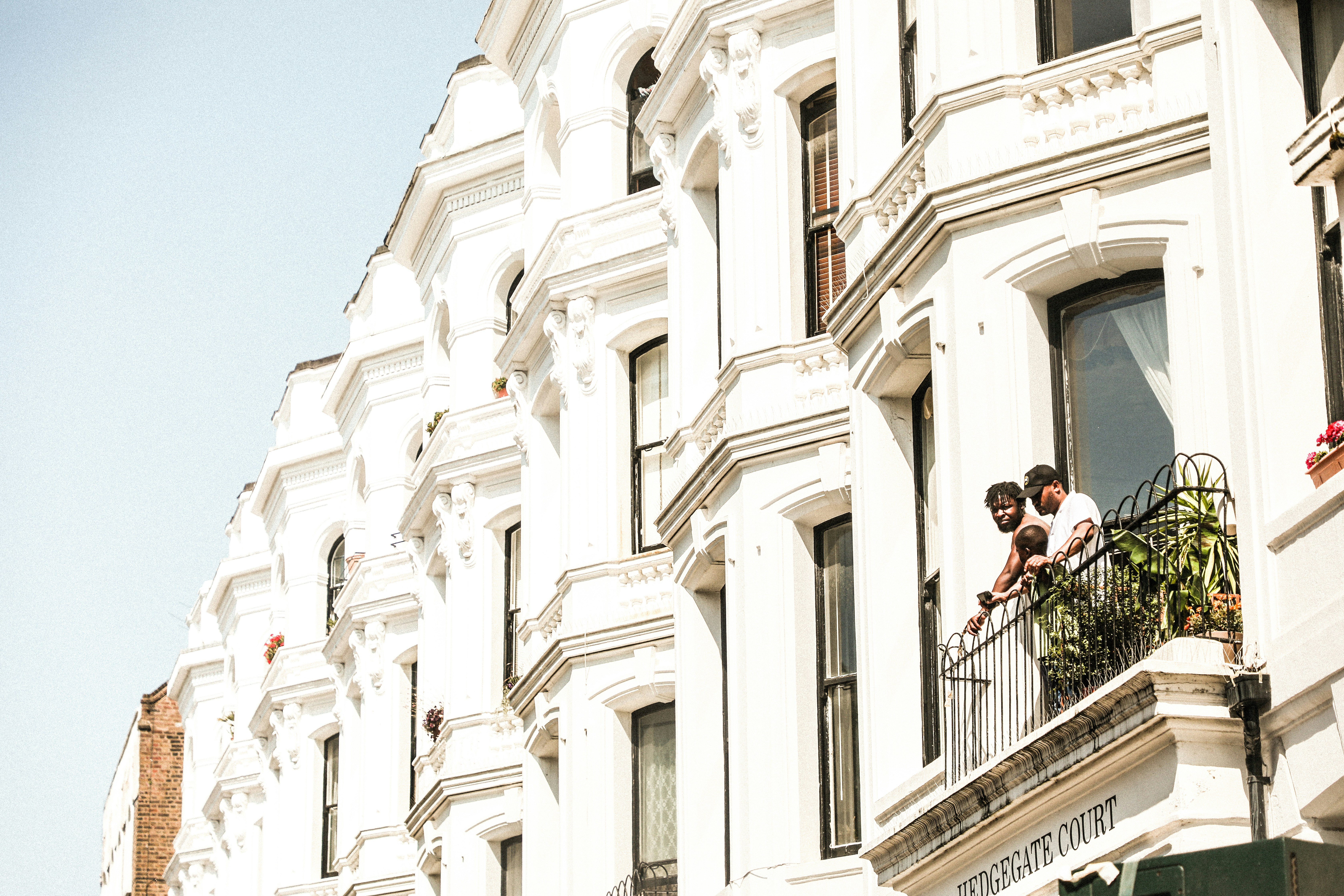 man in black jacket and black pants standing on black metal railings