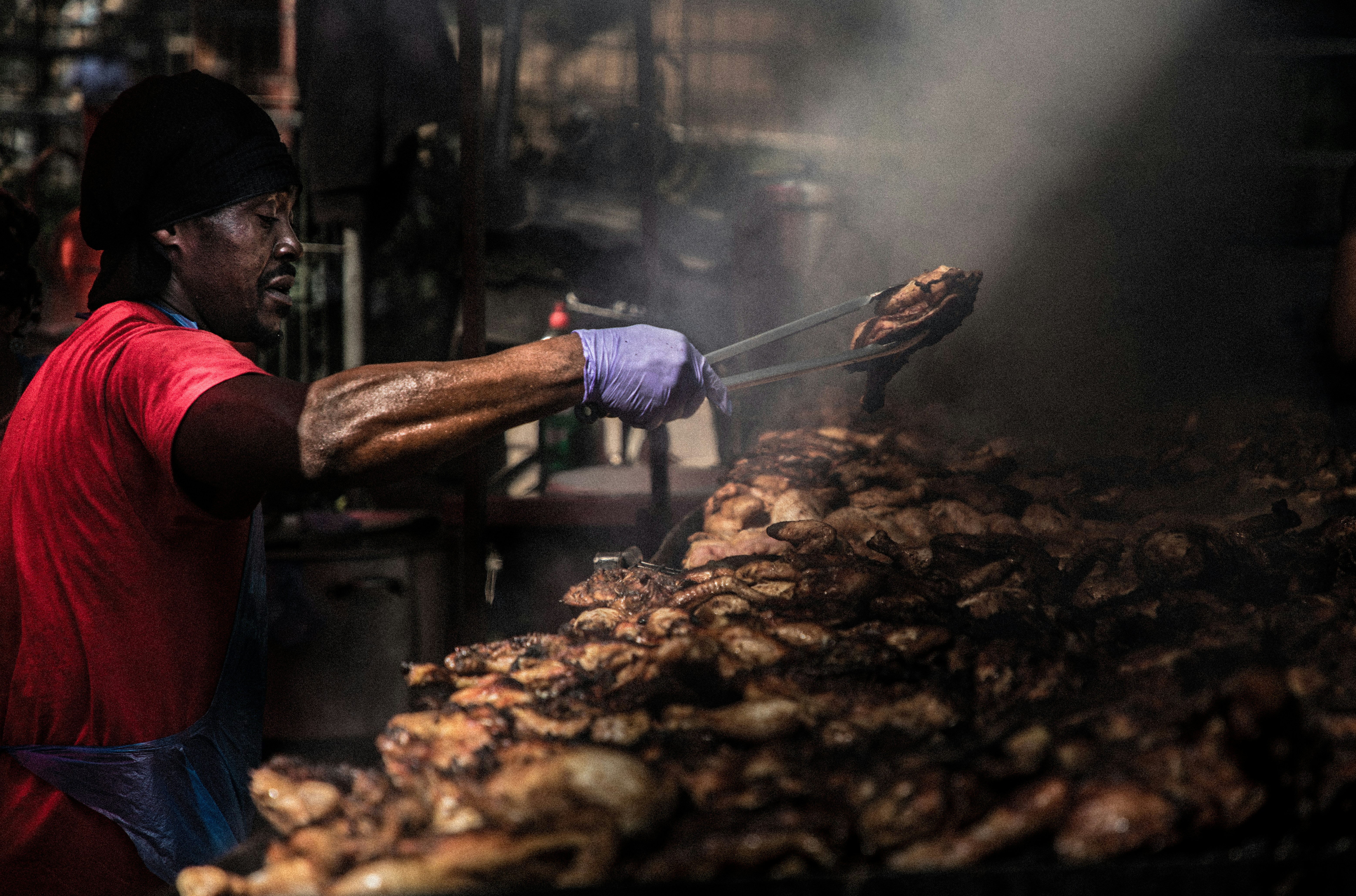 man in blue and white stripe shirt holding gray metal fork and knife