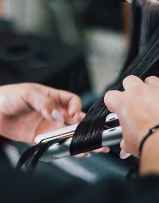 person holding black and silver hand tool