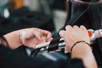 person holding black and silver hand tool