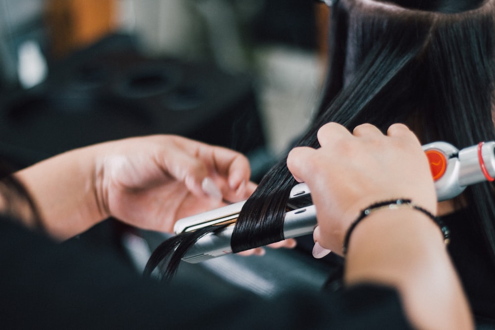 person holding black and silver hand tool