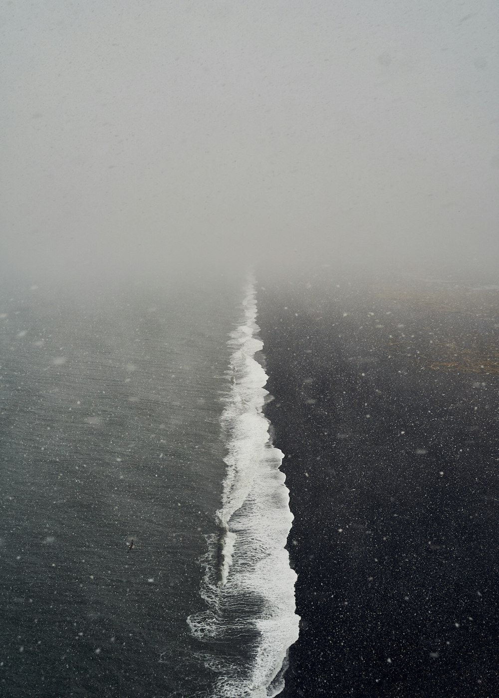 body of water under white sky during daytime