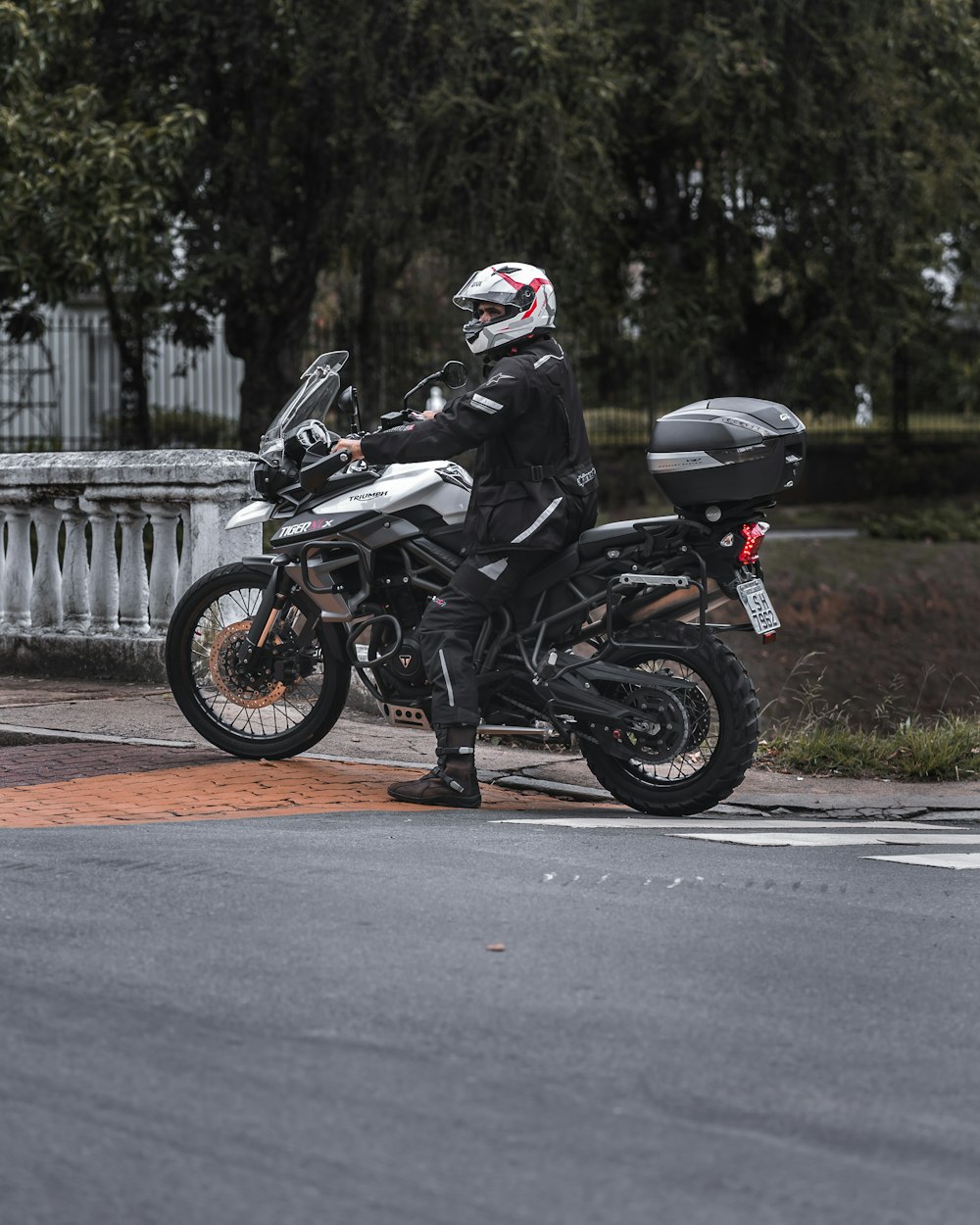 man in black motorcycle helmet riding motorcycle on road during daytime