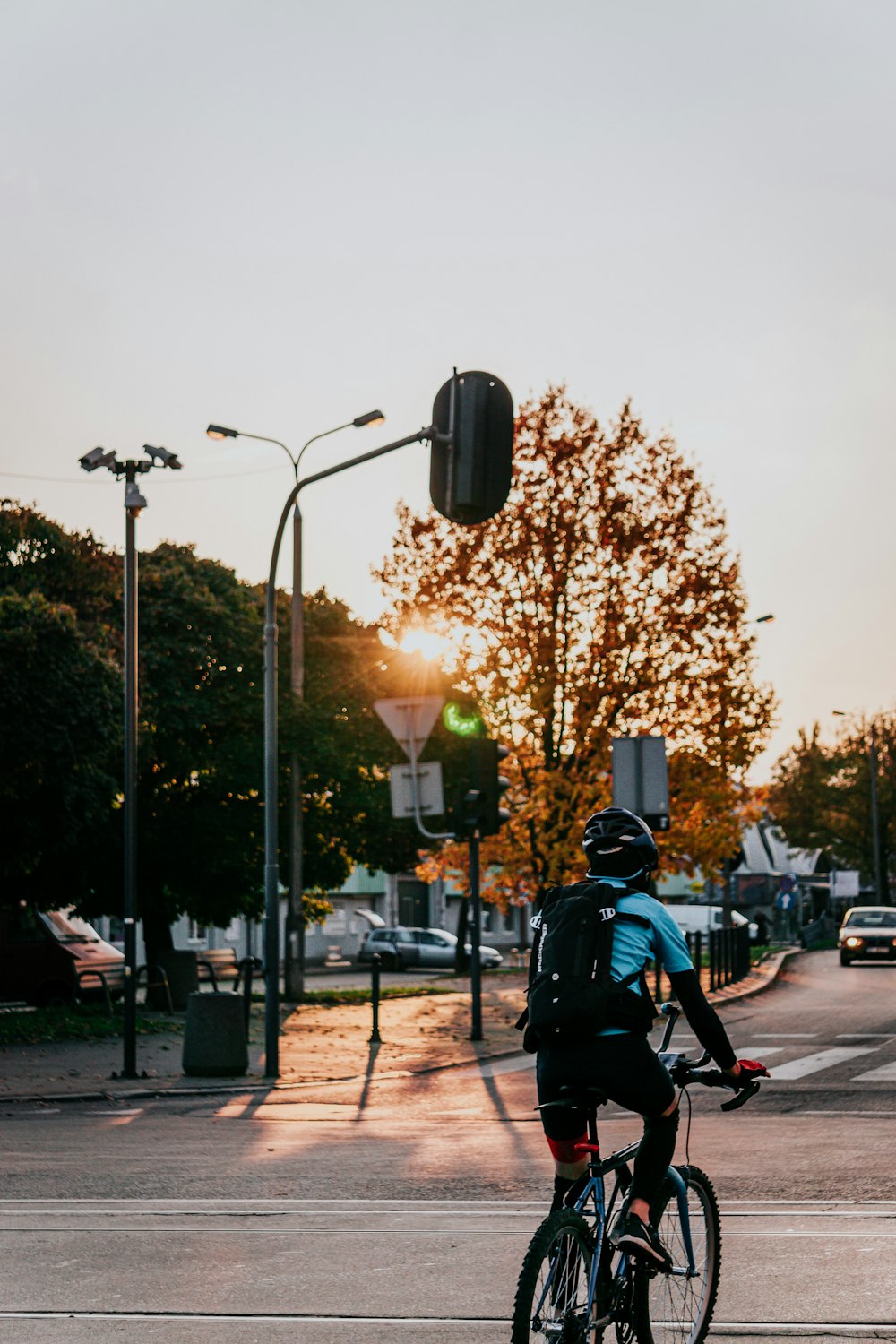 man in black helmet riding bicycle during daytime