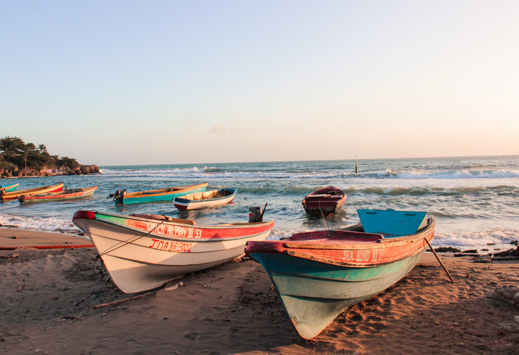 Colourful fishing boats resting on Treasure Beach in Jamaica