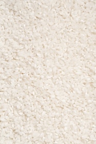 A close-up of a bowl filled with uncooked rice grains.
