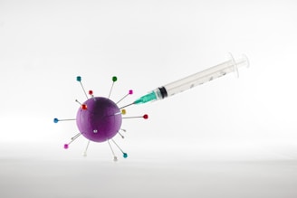 white and green syringe on white surface