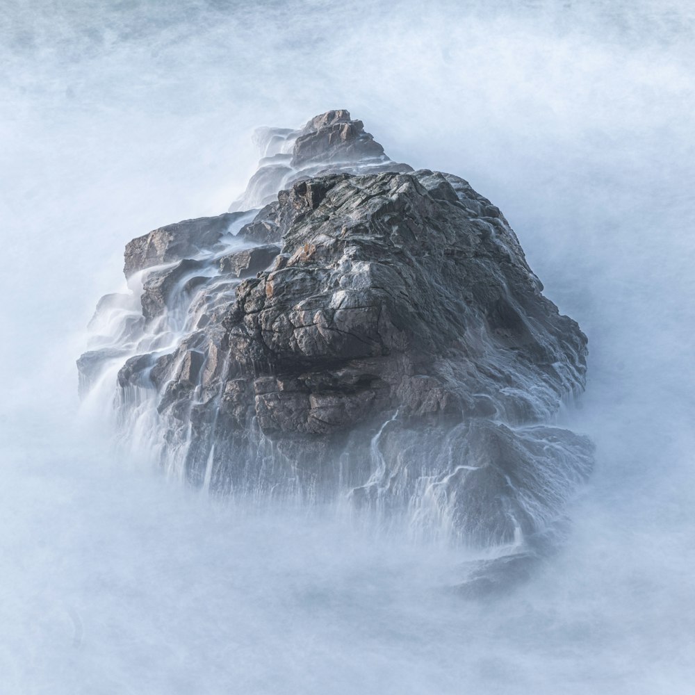 black and white rock formation on white snow covered ground