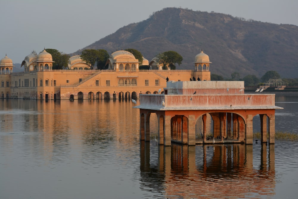 brown concrete building near body of water during daytime