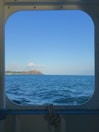 Ocean view from a cruise ship cabin overlooking calm sea waters.
