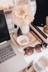 black framed sunglasses beside white flower