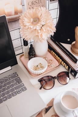 black framed sunglasses beside white flower