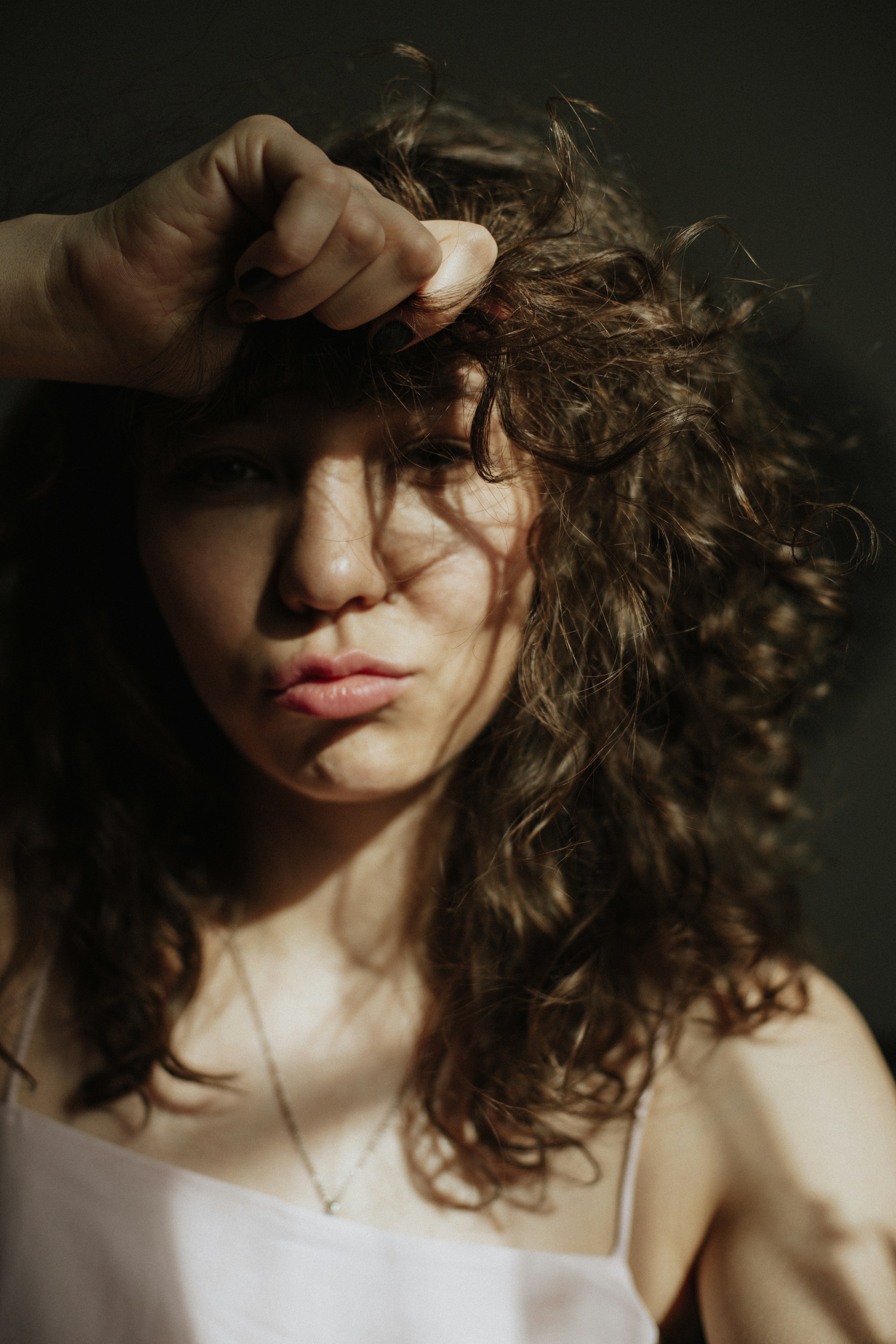 a woman with curly hair wearing hair extensions