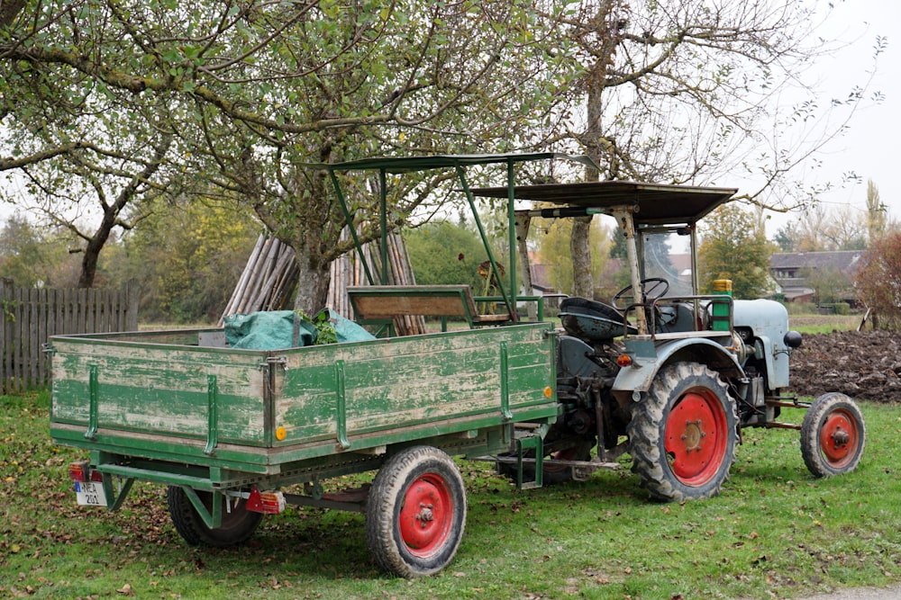 green and brown tractor on green grass field during daytime