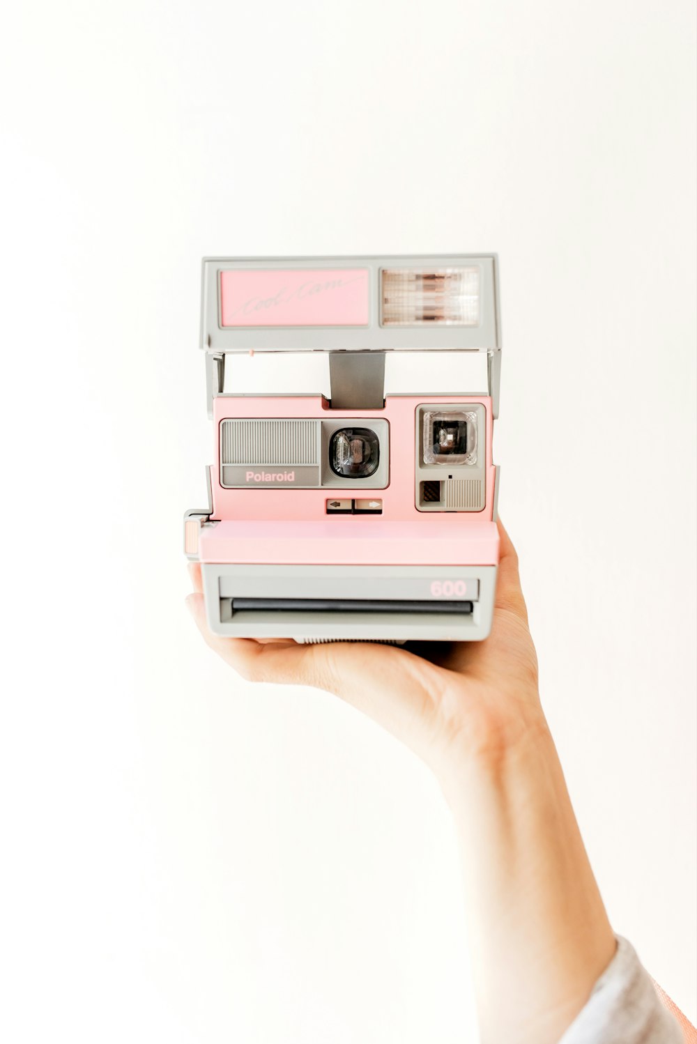pink and white polaroid camera