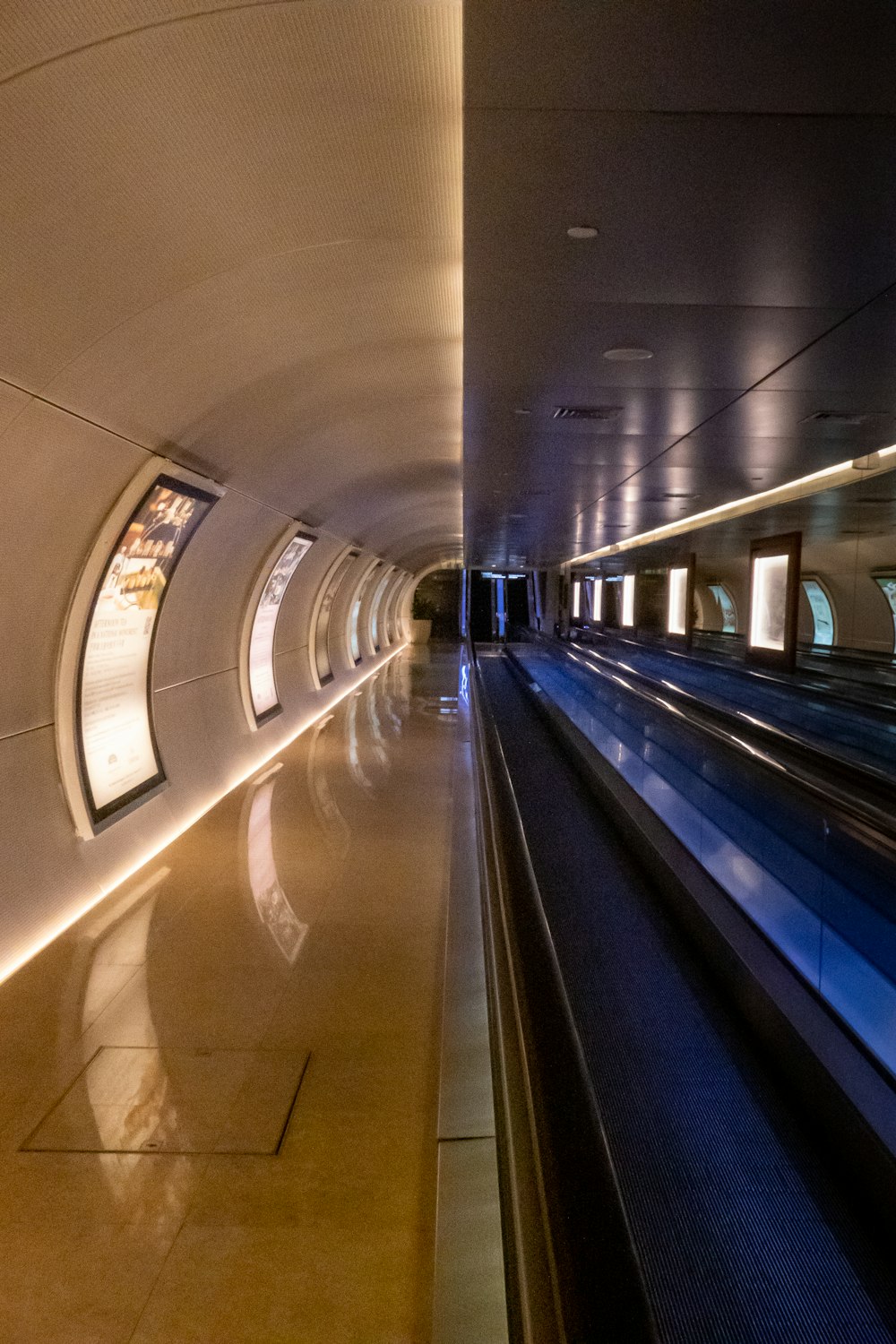 white and blue train in a tunnel