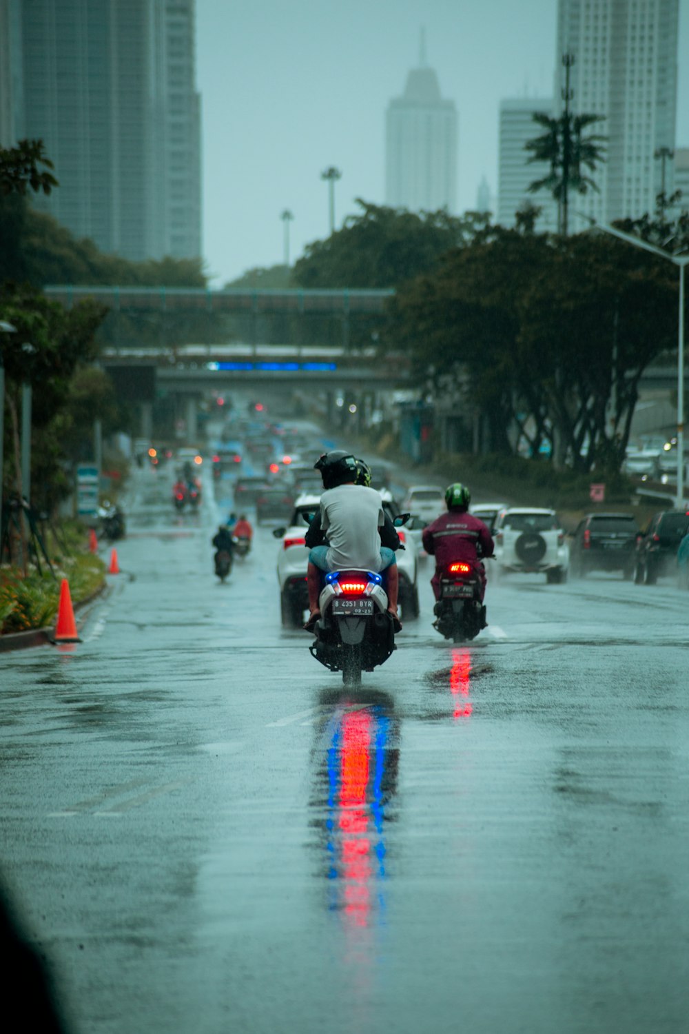 man in black jacket riding motorcycle on road during daytime