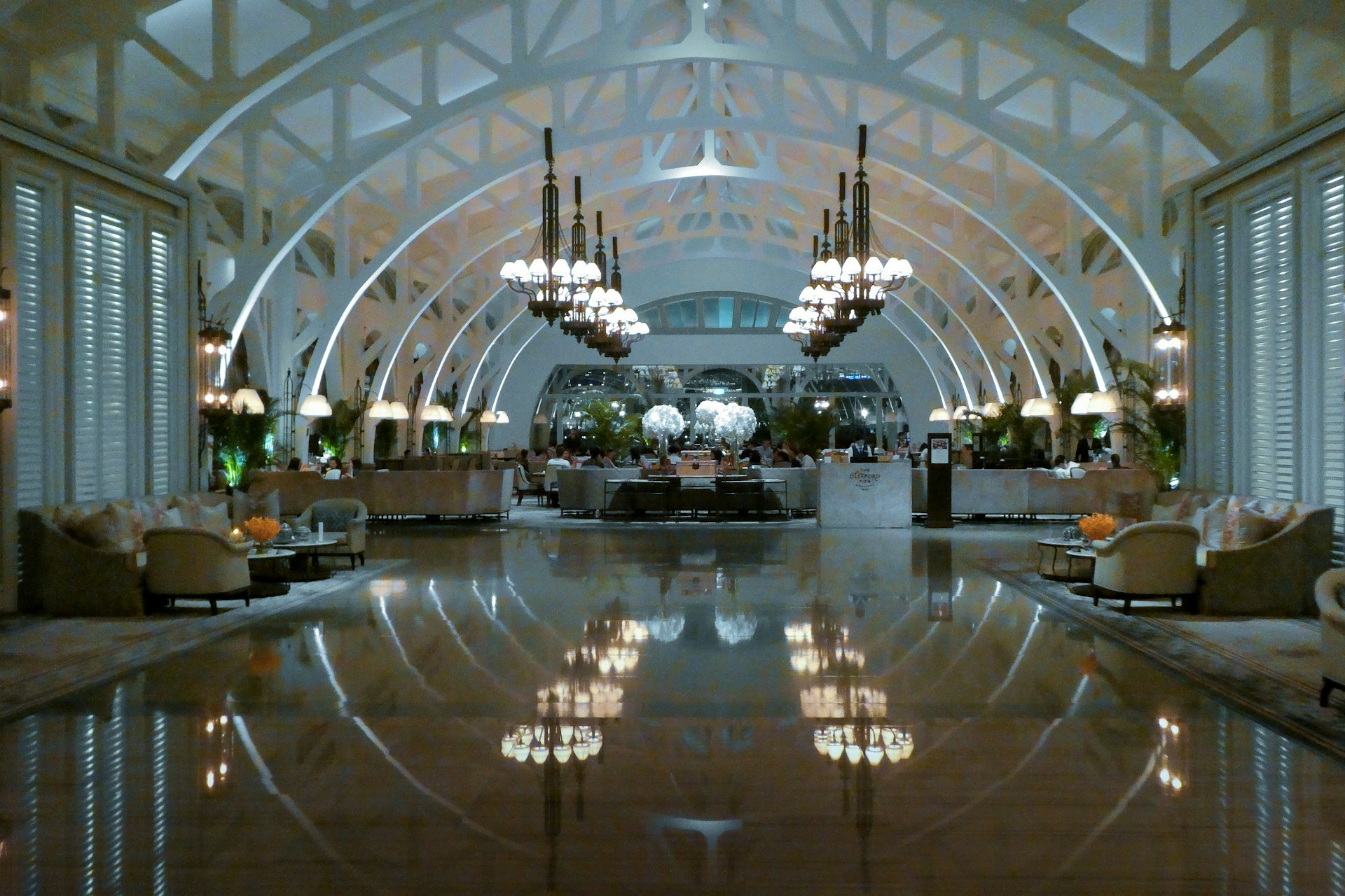 people walking inside building with glass walls