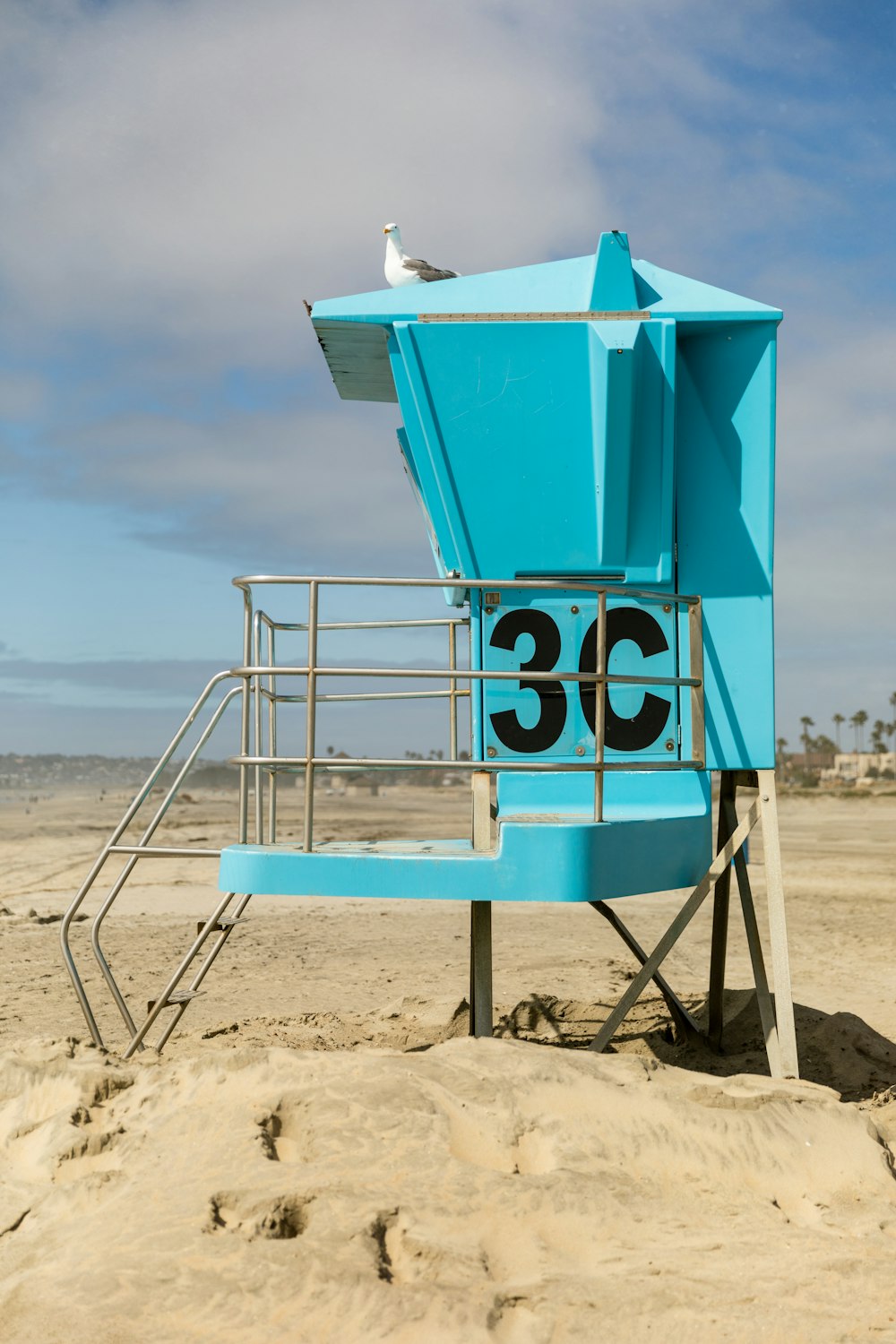 blue lifeguard tower on beach during daytime