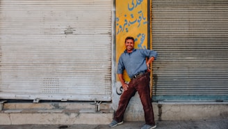 Friendly local handyman and painter smiling while working on a home exterior in Tenerife.